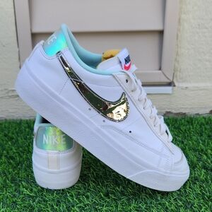 Nike Women's White Sneakers with Metallic Gold Swoosh and Mint Accents